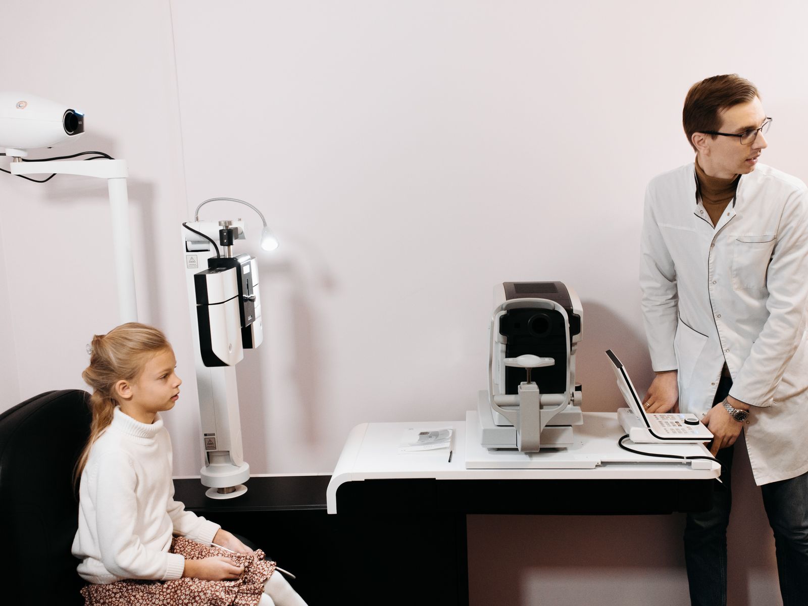 Dentist talking with a patient seated in a dental chair during consultation