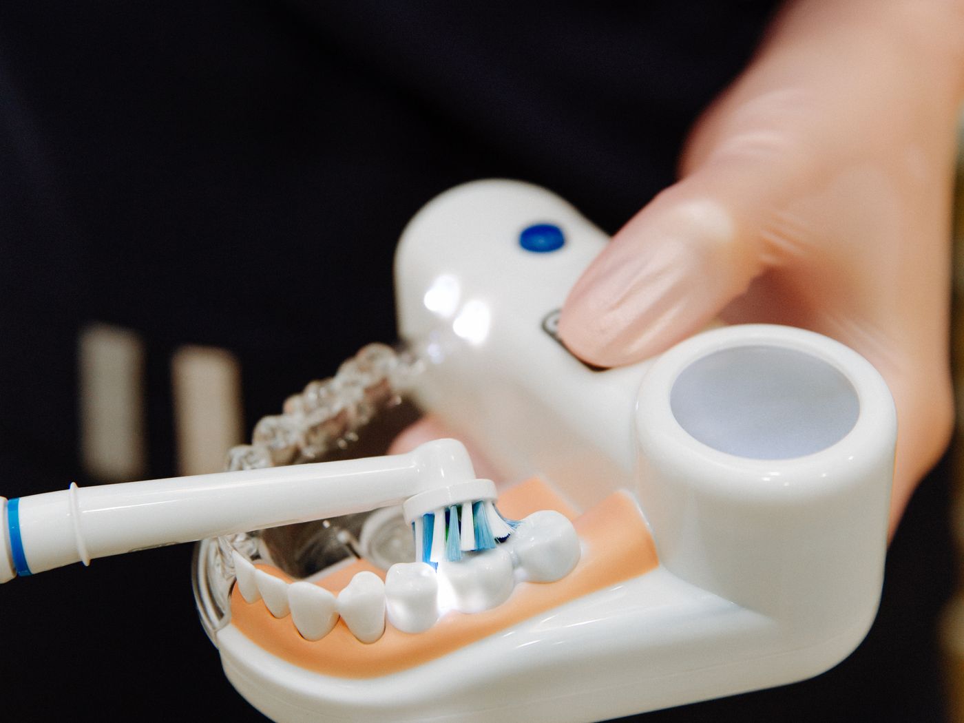 Dental professional performing an ultrasonic scaling procedure on a patient's teeth